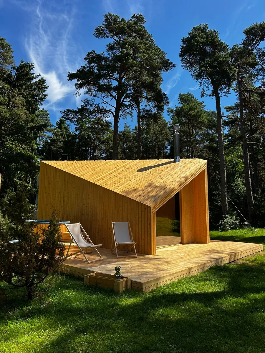 Zen with two deck chairs on its terrace, tall pines behind