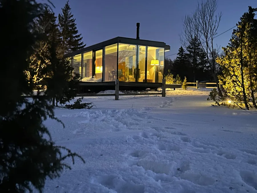 Signature glowing warmly in a snowy landscape after dark