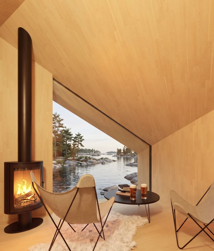 Warm timber lounge with a wood-burning stove and a wide coastal view
